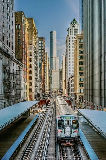 Train traveling through a cityscape, representing hydraulic solutions for the transportation industry