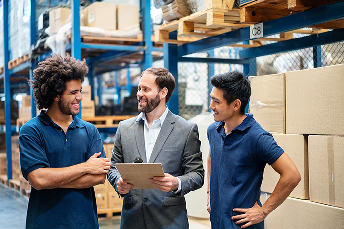 Team discussion in a warehouse representing Hydraulic Supply Company's affiliates and resellers program
