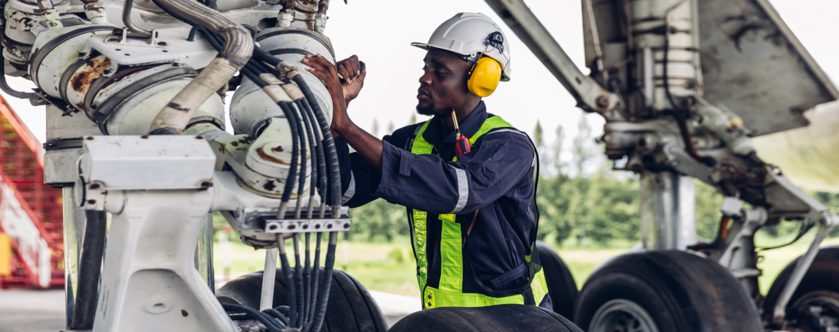 Person doing preventive maintenance on hydraulic system