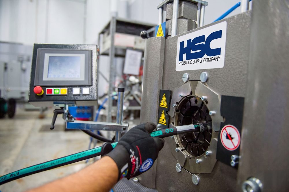 Hydraulic Supply Company technician assembling a hose to locked BOM specifications on an Eaton ET5050 in-house